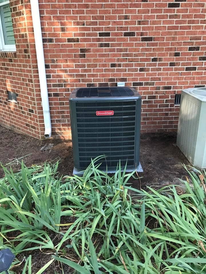 AC condenser installation against a brick house in Erwin, NC